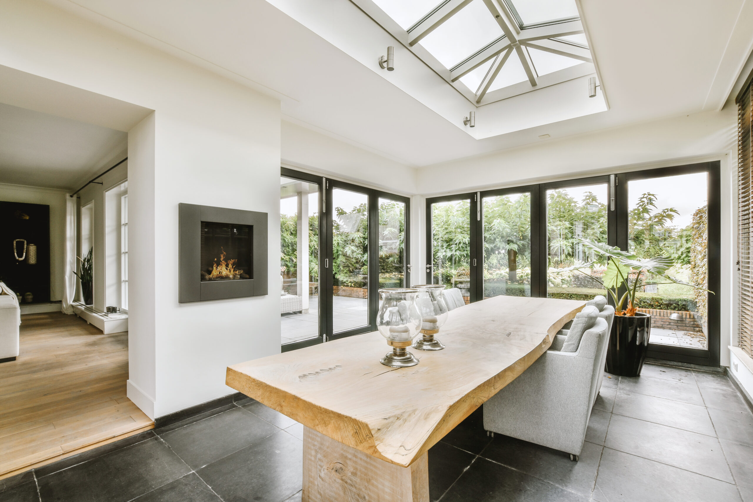 Modern dining area with large windows and pyramid rooflight